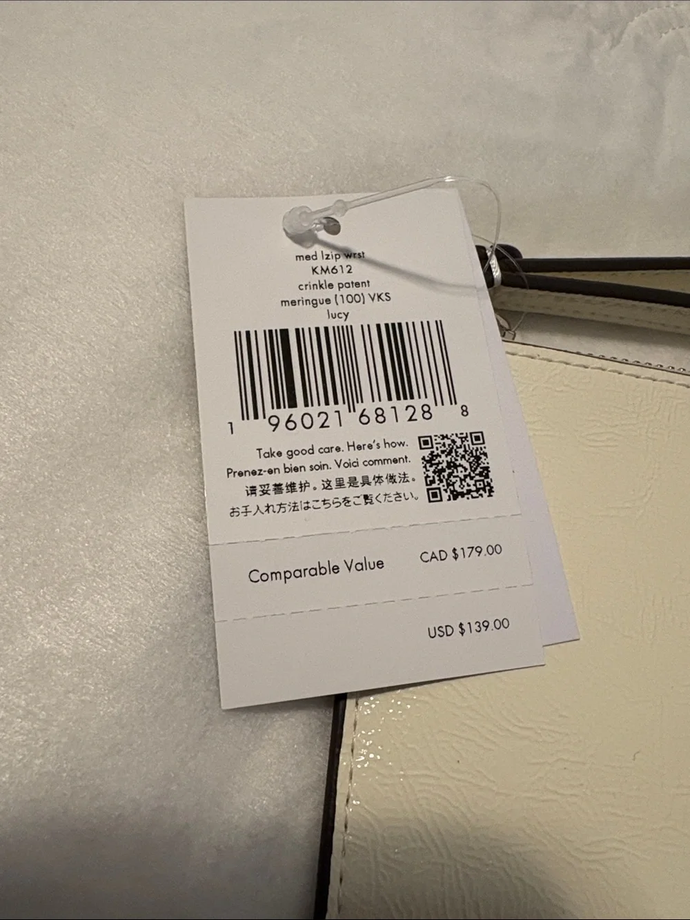 kate spade cream patent leather wristlet with gold logo